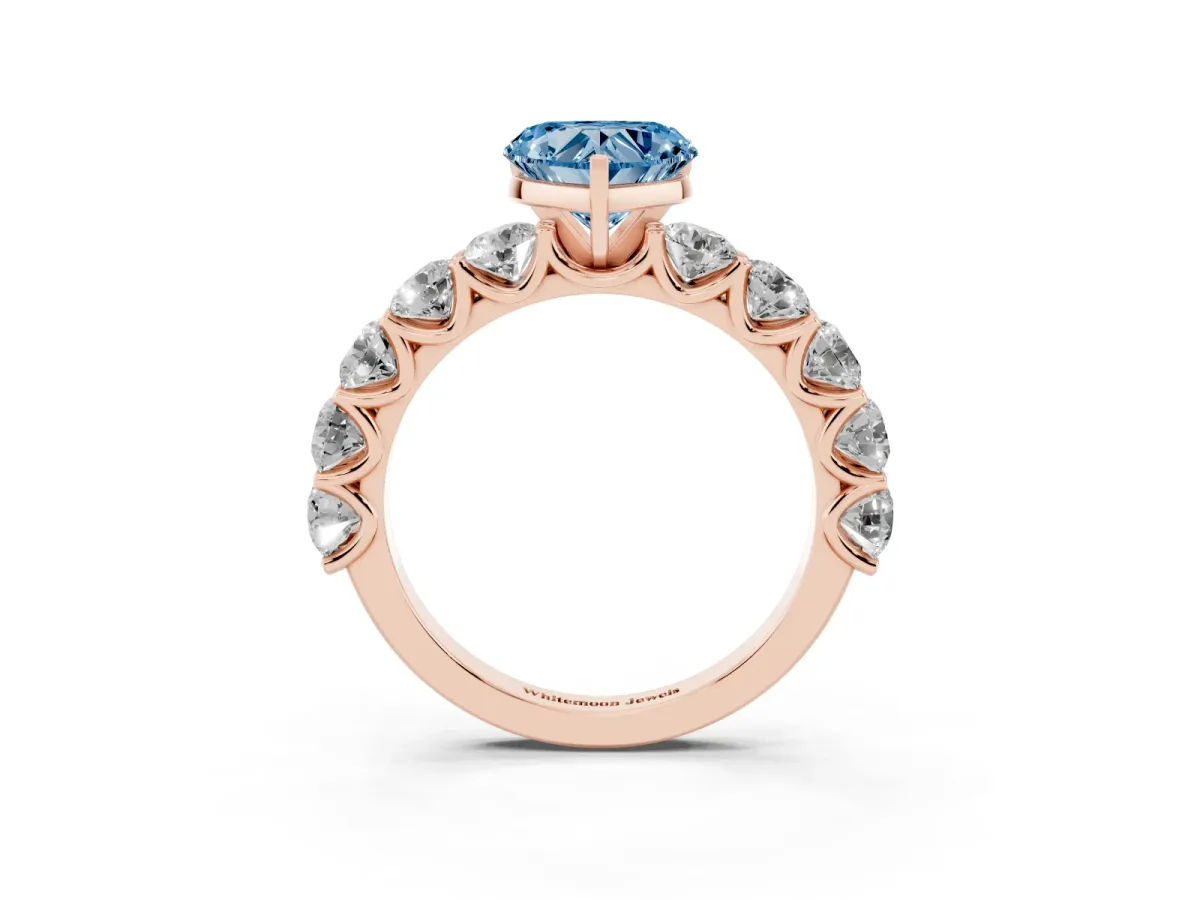 Fancy Blue Heart Cut Diamond Prong Setting with Side Stones on a Pave Band Rose gold