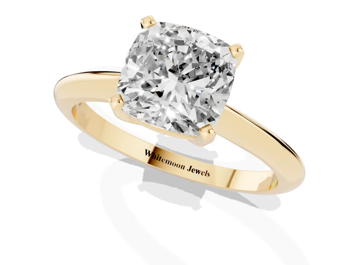Cushion Cut Cut Solitaire Ring with Four-Prong Setting on a Classic Band Yellow gold