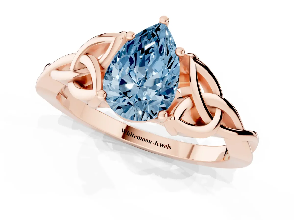 Fancy Blue Pear Cut Diamond Solitaire Engagement Ring with Celtic Knot Band and Four-Prong Setting Rose gold