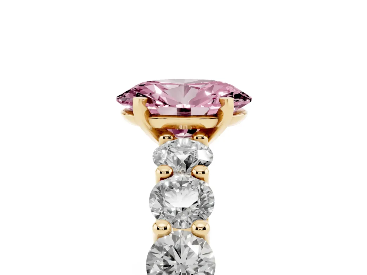 Fancy Pink Oval Cut Diamond Prong Setting with Side Stones on a Pave Band Yellow gold