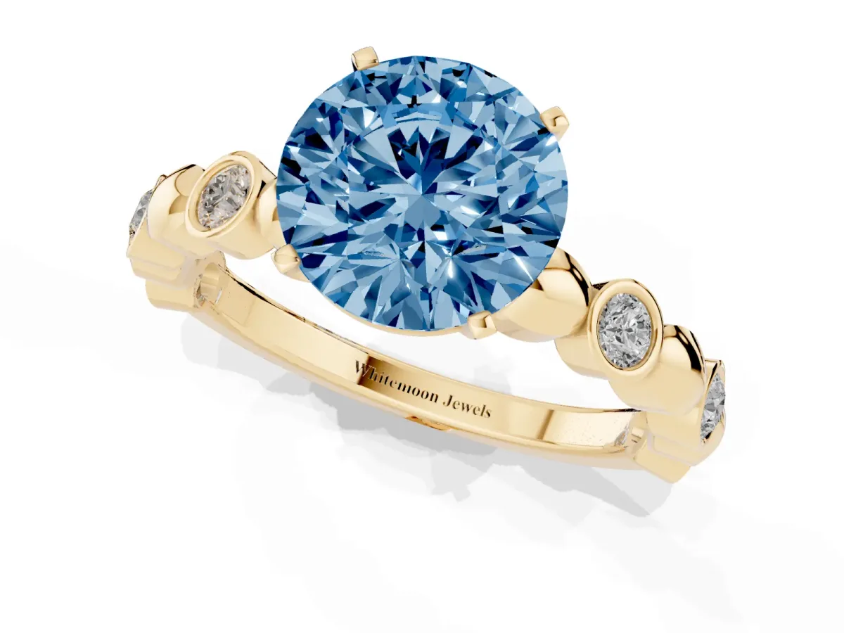 Fancy Blue Round Cut Solitaire Bezel-Set Diamond Ring with Beaded Band and Four-Prong Setting Yellow gold
