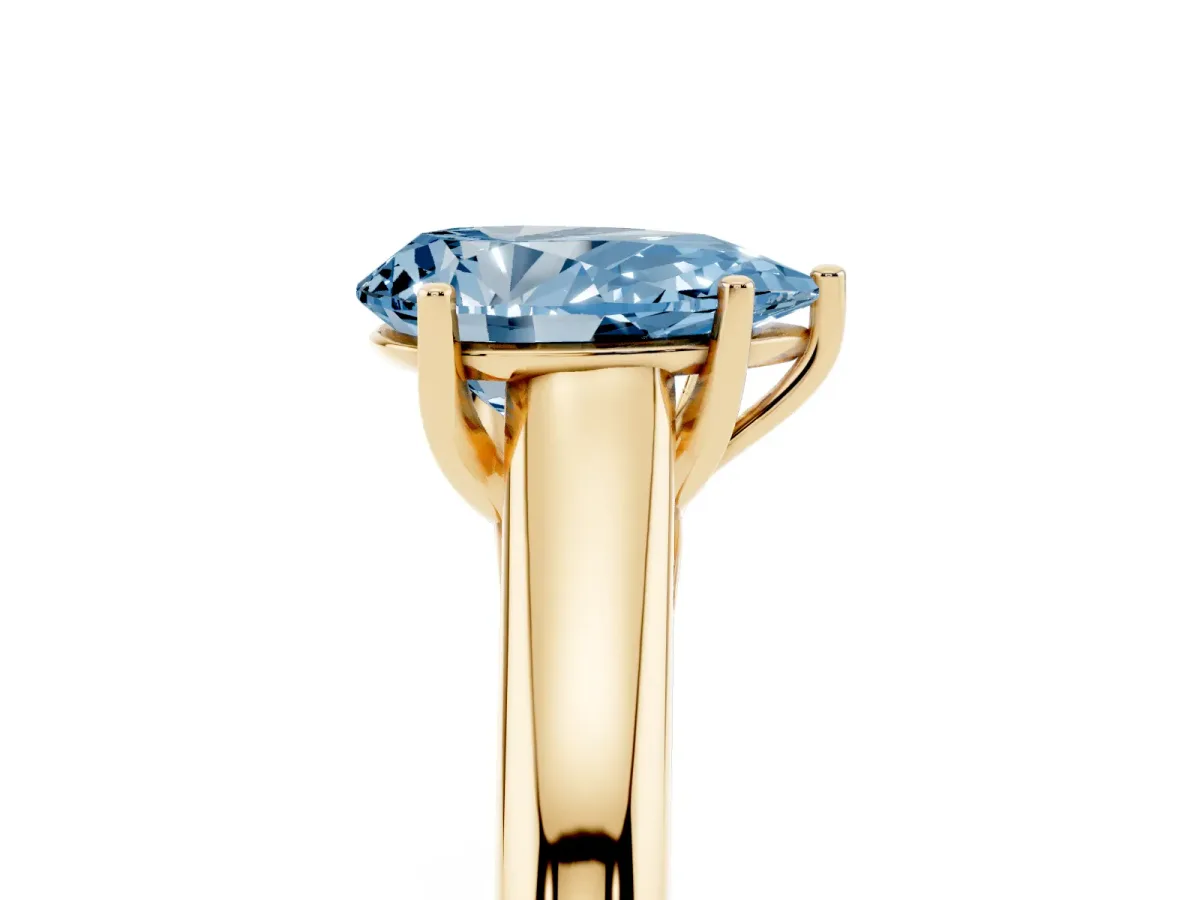 Fancy Blue Pear Cut Solitaire Engagement Ring with Tapered Band and Four-Prong Setting Yellow gold