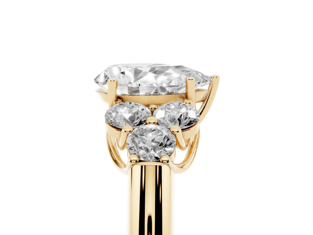 Pear Cut Cut Diamond Cluster Ring with Round Accent Stones and Prong Setting on a Classic Band Yellow gold