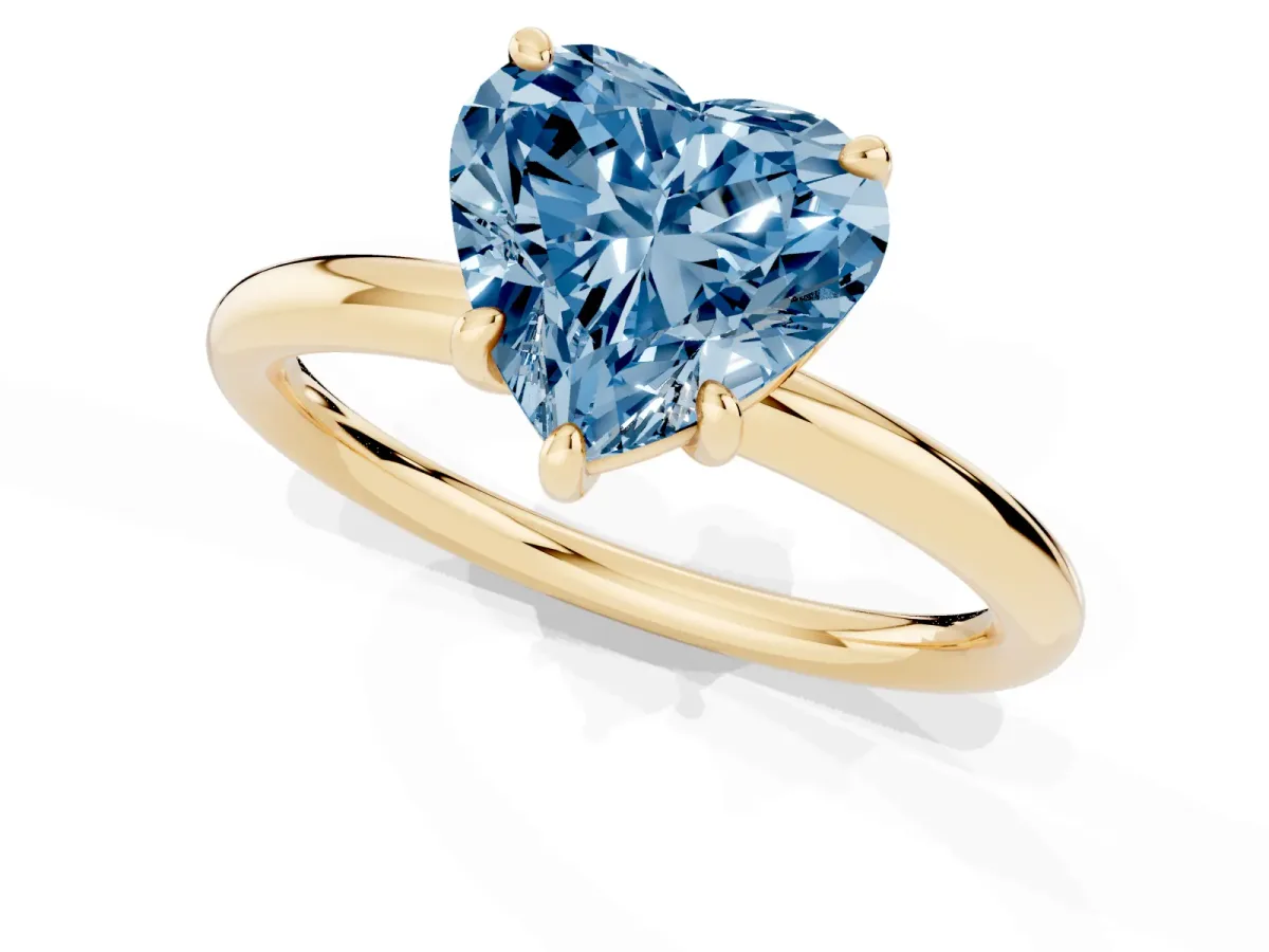 Fancy Blue Heart Cut Solitaire Diamond Ring with Four-Prong Setting on a Plain Band Yellow gold