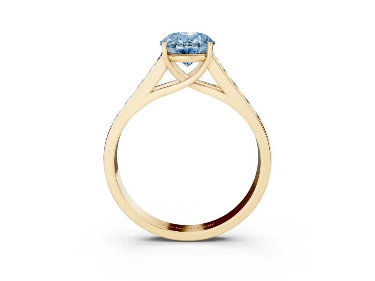 Fancy Blue Oval Cut Brilliant Channel-Set Solitaire Ring with Four-Prong Setting Yellow gold