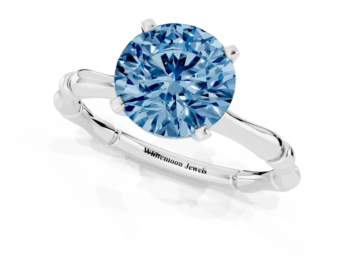 Fancy Blue Round Cut Solitaire Diamond Ring with Bamboo Band and Four-Prong Setting Silver