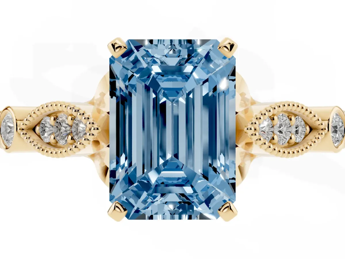 Fancy Blue Emerald Cut Cut Diamond with Milgrain Marquise and Bezel Accents on a Solitaire Band with Prong Setting Yellow gold
