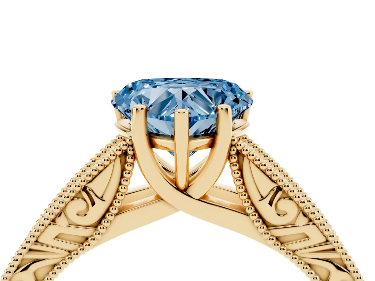 Fancy Blue Heart Cut Diamond Solitaire Ring with Engraved Band and Four-Prong Setting Yellow gold