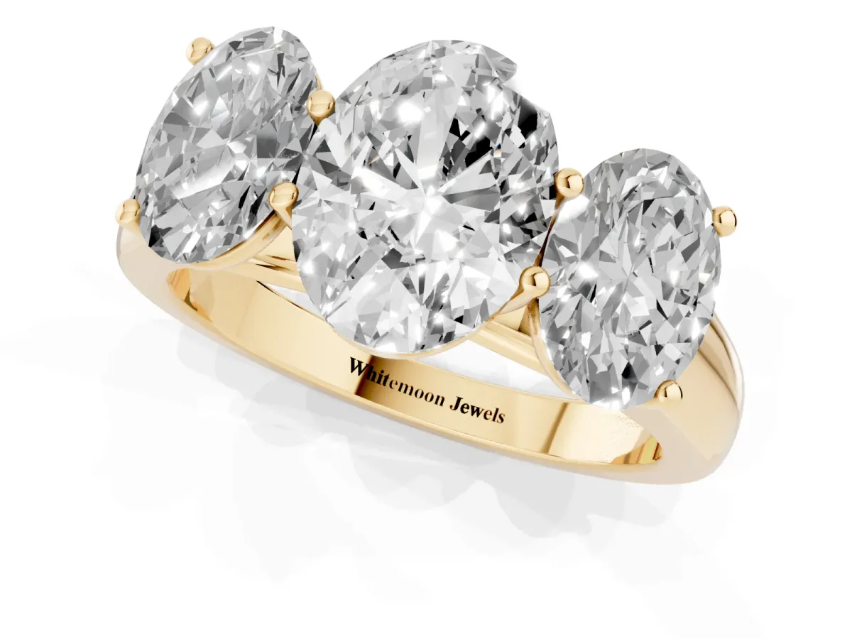 Oval Cut Three-Stone Diamond Ring with Prong Setting on a Classic Band Yellow gold