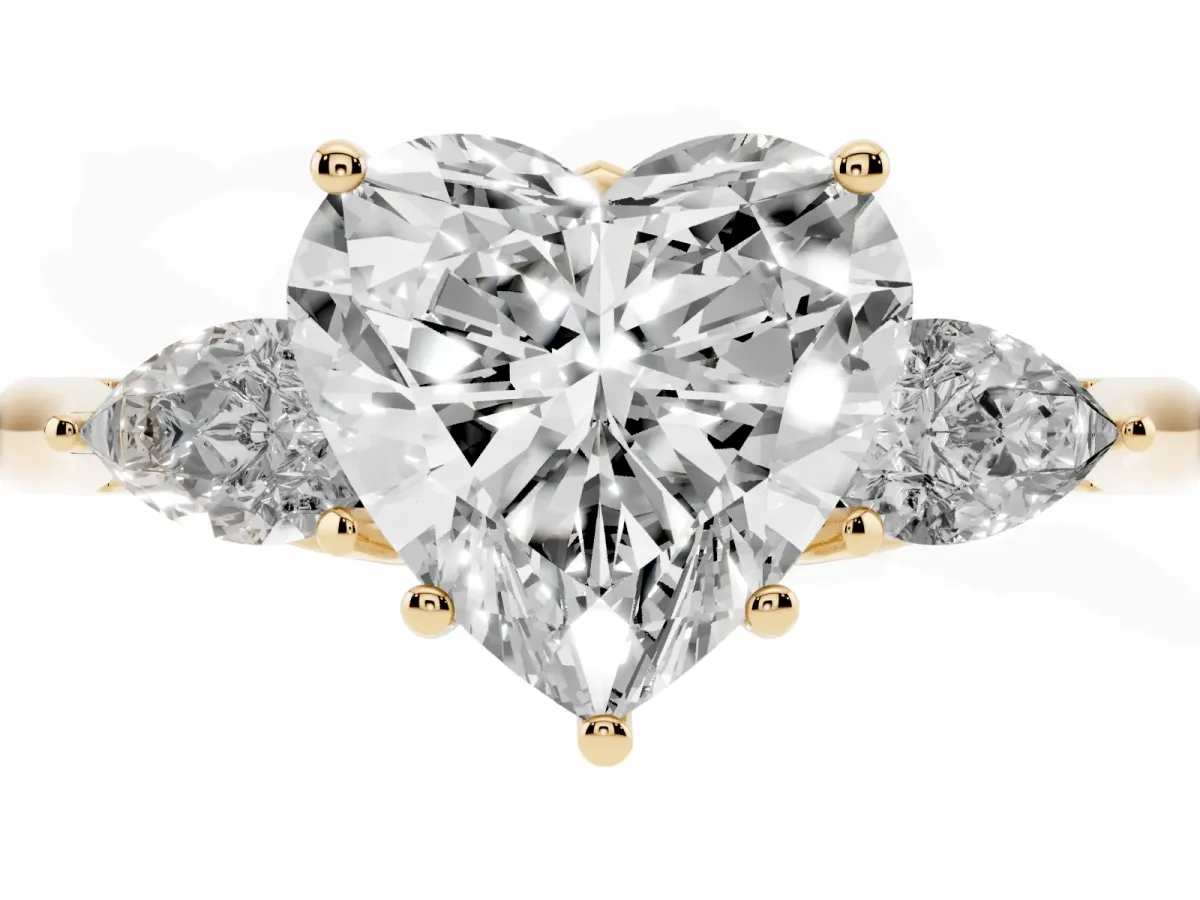 Three-Stone Heart Cut Diamond Ring with Pear Side Stones in Four-Prong Setting Yellow gold