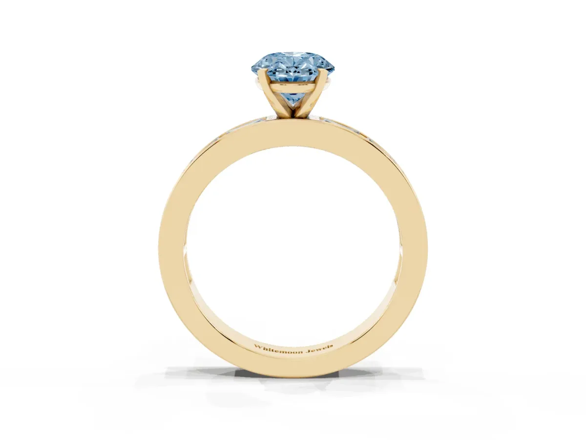 Fancy Blue Oval Cut Solitaire Diamond Ring with Channel-Set Baguette Band and Four-Prong Setting Yellow gold