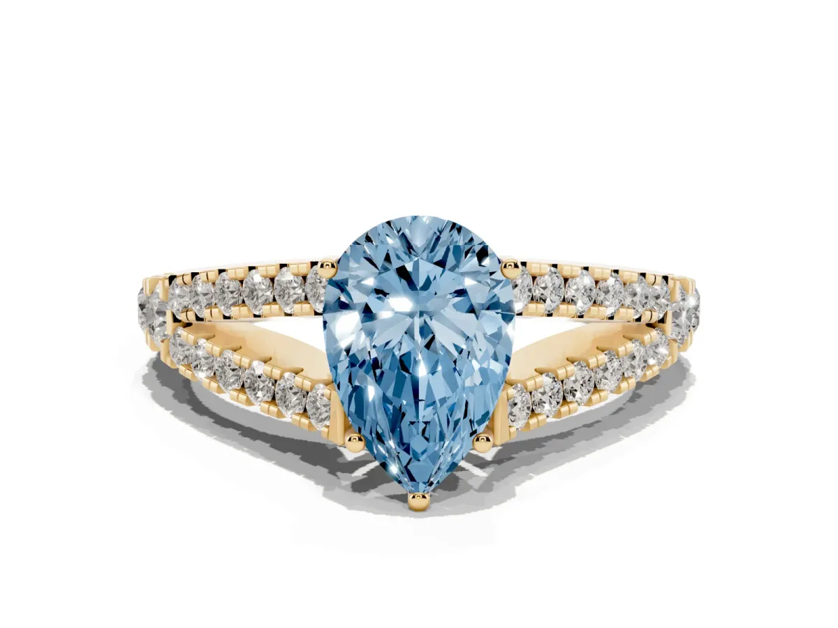 Fancy Blue Pear Cut Diamond Split Shank Engagement Ring with Round Pavé and Prong Setting Yellow gold