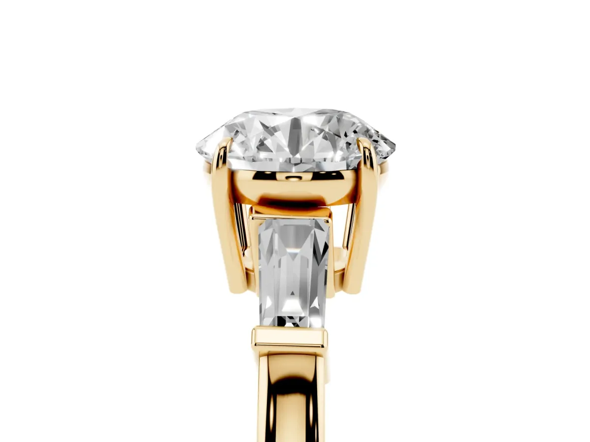 Round Cut Diamond Three-Stone Ring with Tapered Baguette Side Stones and Prong Setting Yellow gold