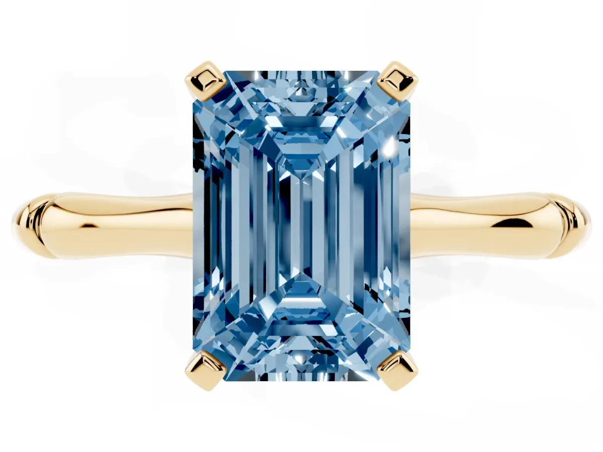 Fancy Blue Emerald Cut Solitaire Diamond Ring with Bamboo Band and Four-Prong Setting Yellow gold