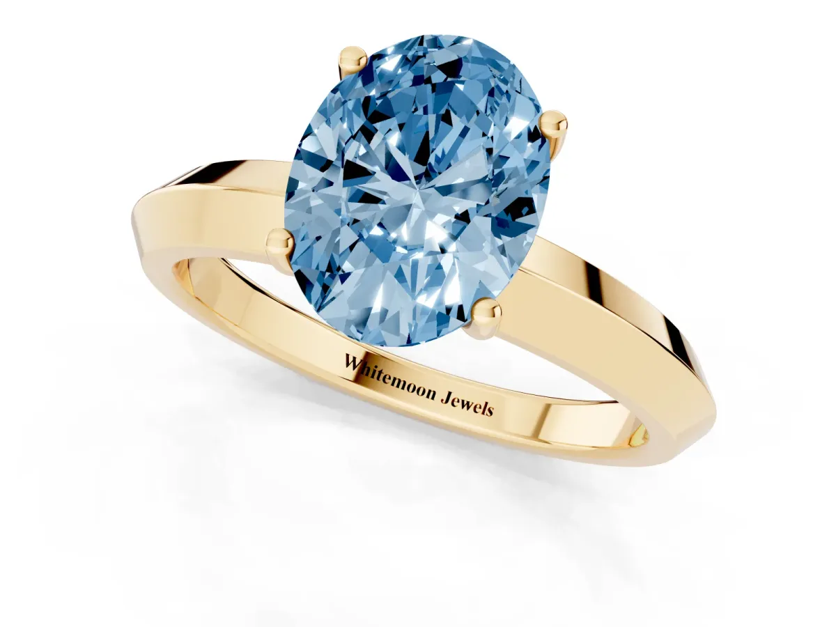 Fancy Blue Oval Cut Cut Solitaire Engagement Ring with Flat Band and Four-Prong Setting Yellow gold