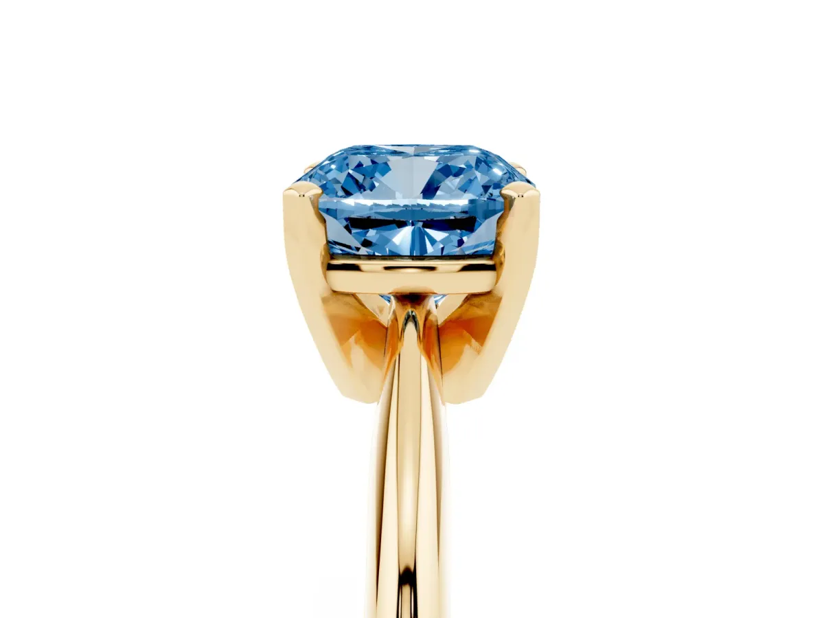 Fancy Blue Cushion Cut Cut Solitaire Ring with Four-Prong Setting on a Classic Band Yellow gold