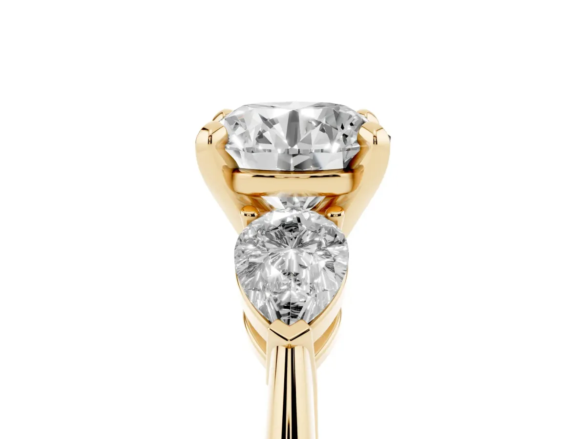 Three-Stone Round Cut Diamond Ring with Pear Side Stones and Four-Prong Setting Yellow gold