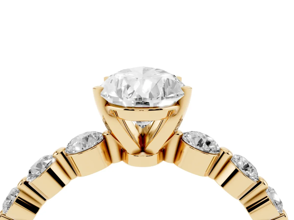 Pear Cut Solitaire Diamond Ring with Pave Band and Four-Prong Setting Yellow gold