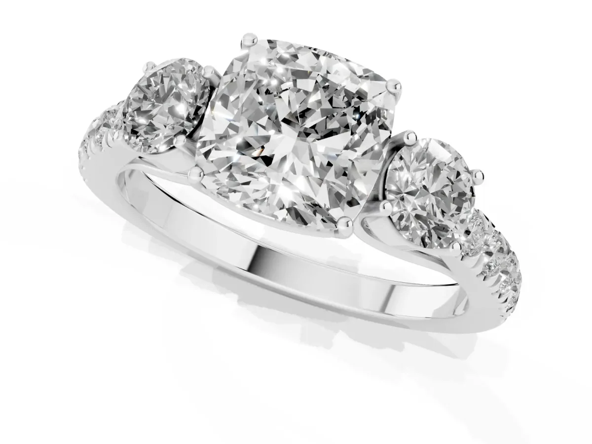 Cushion Cut Cut Diamond Three-Stone Ring with Round Side Stones and Pavé Band Platinum