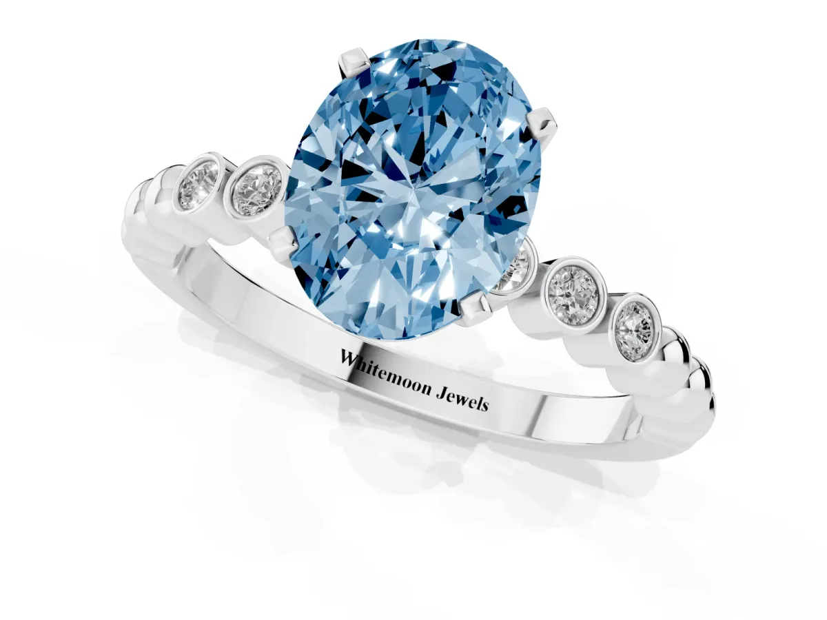 Fancy Blue Oval Cut Solitaire Bezel Accent Diamond Engagement Ring with Beaded Band and Four-Prong Setting White gold
