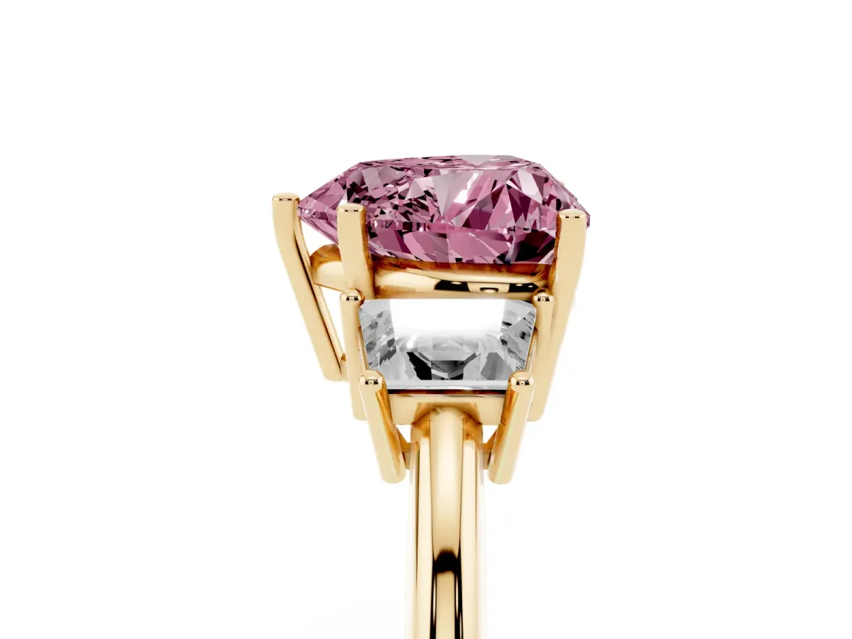 Fancy Pink Heart Cut Diamond Three-Stone Ring with Trapezoid Side Stones and Prong Setting Yellow gold