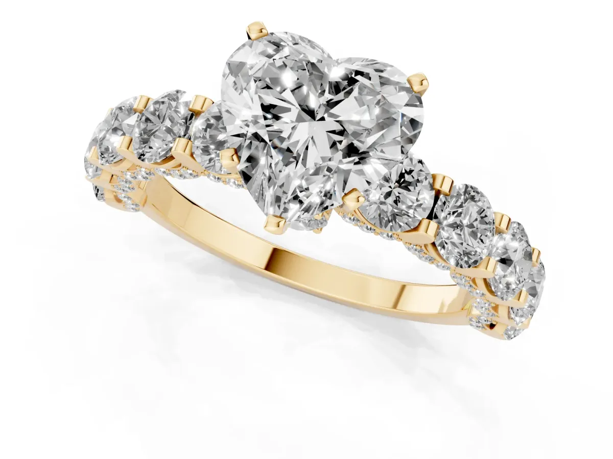 Heart Cut Diamond Side Stone Engagement Ring with Four-Prong Setting Yellow gold