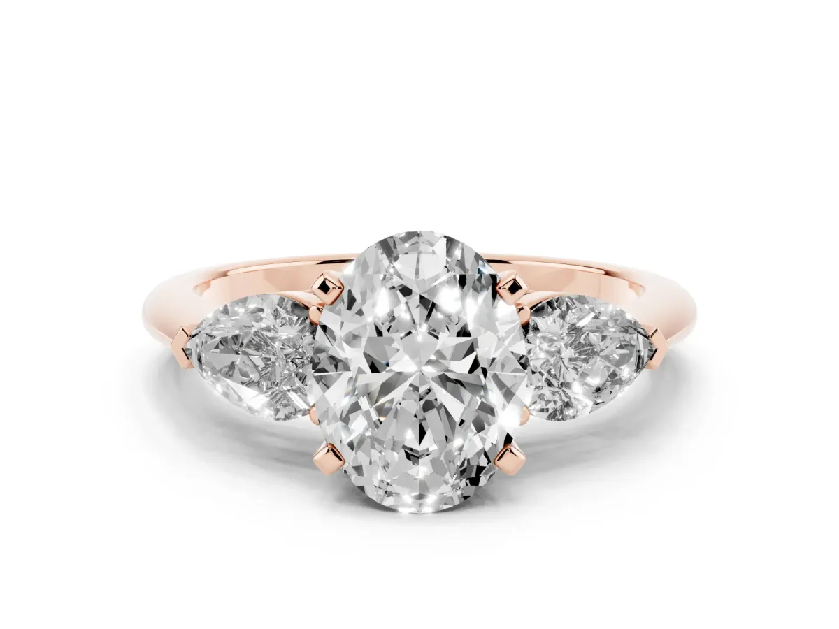 Three-Stone Oval Cut Diamond Ring with Pear Side Stones and Four-Prong Setting Rose gold