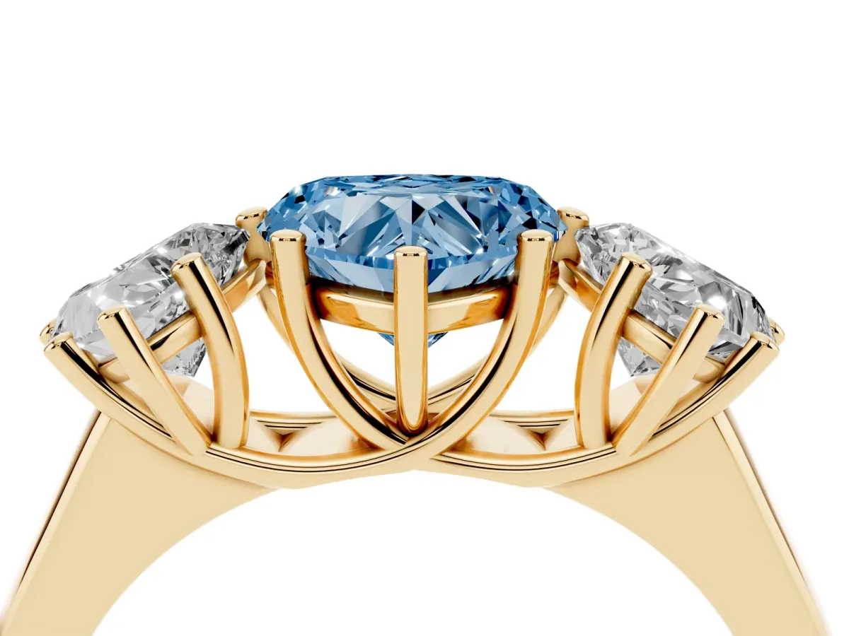 Fancy Blue Heart Cut Three-Stone Diamond Ring with Prong Setting on a Classic Band Yellow gold