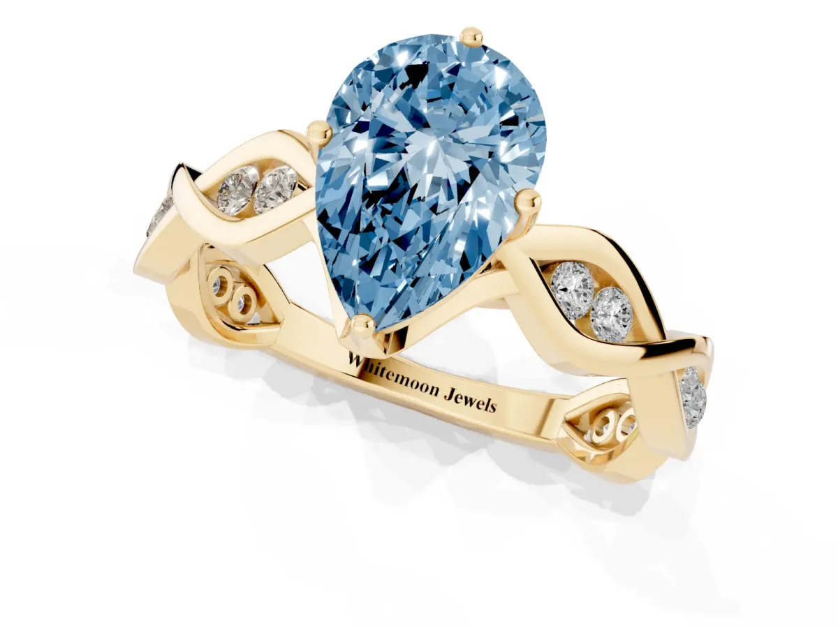 Fancy Blue Pear Cut Solitaire Twist Band with Leaf Prong Setting Yellow gold