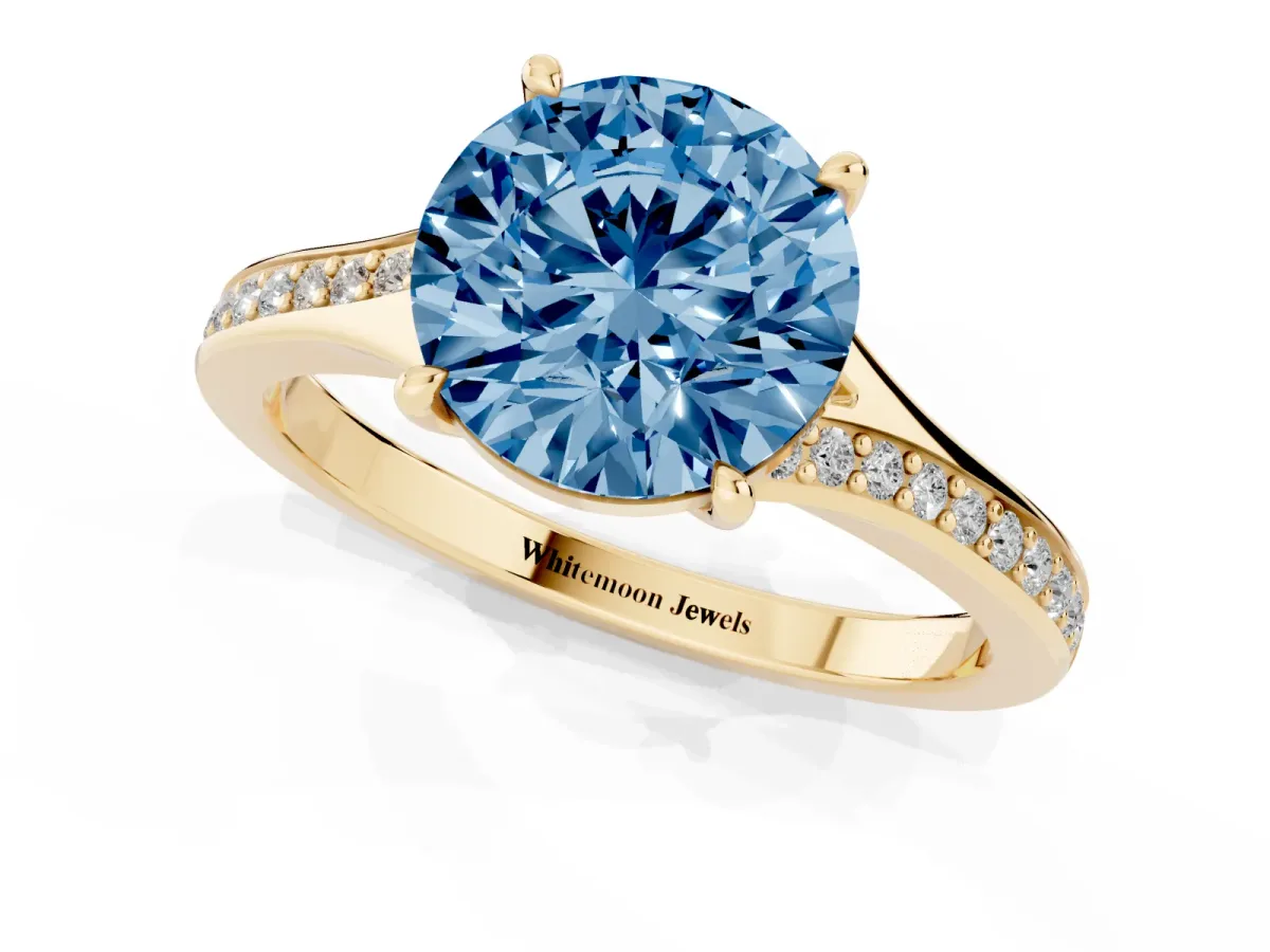 Fancy Blue Round Cut Diamond Solitaire Ring with Pavé Band and Prong Setting Yellow gold
