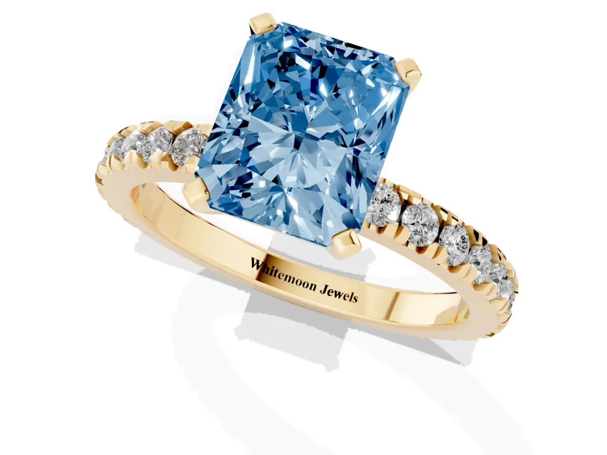 Fancy Blue Radiant Cut Diamond Pavé Band Solitaire with Four-Prong Setting Yellow gold