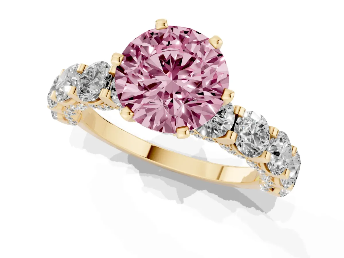 Fancy Pink Round Cut Diamond Side Stone Engagement Ring with Four-Prong Setting Yellow gold