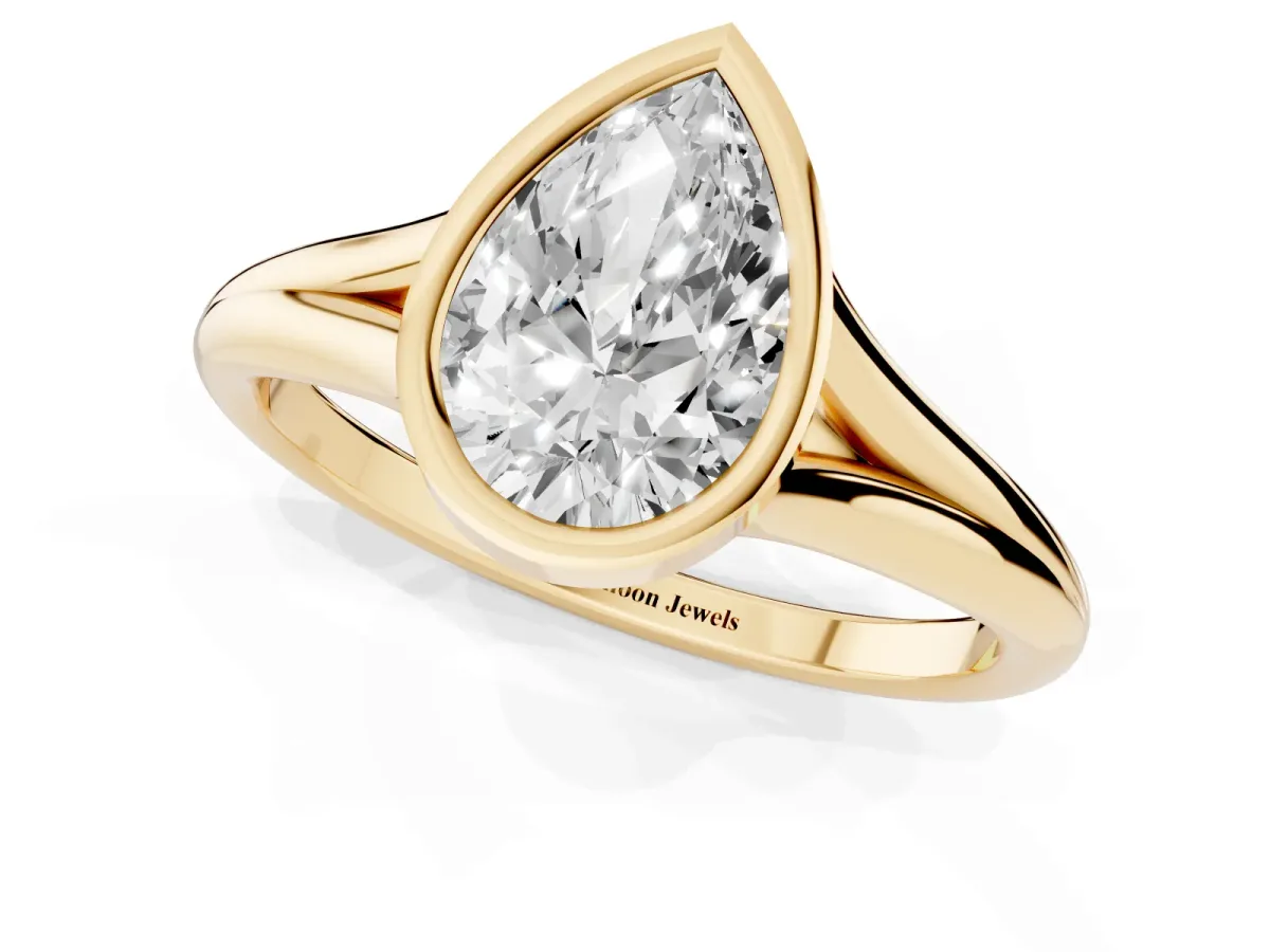 Bezel Set Pear Cut Cut Solitaire Ring with Tapered Band Yellow gold