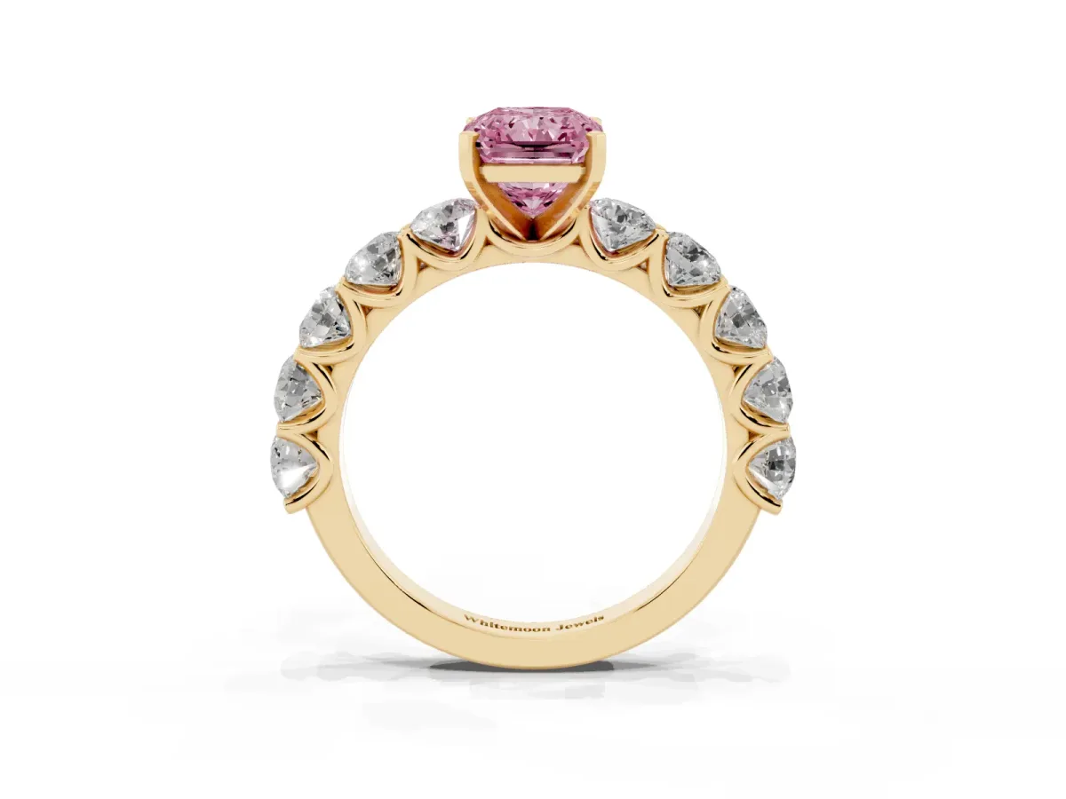 Fancy Pink Radiant Cut Diamond Prong Setting with Side Stones on a Pave Band Yellow gold
