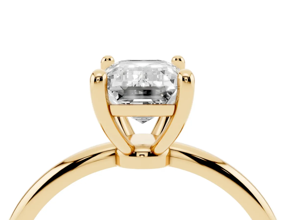 Emerald Cut Solitaire Diamond Ring with 4-Prong Setting on a Classic Band Yellow gold