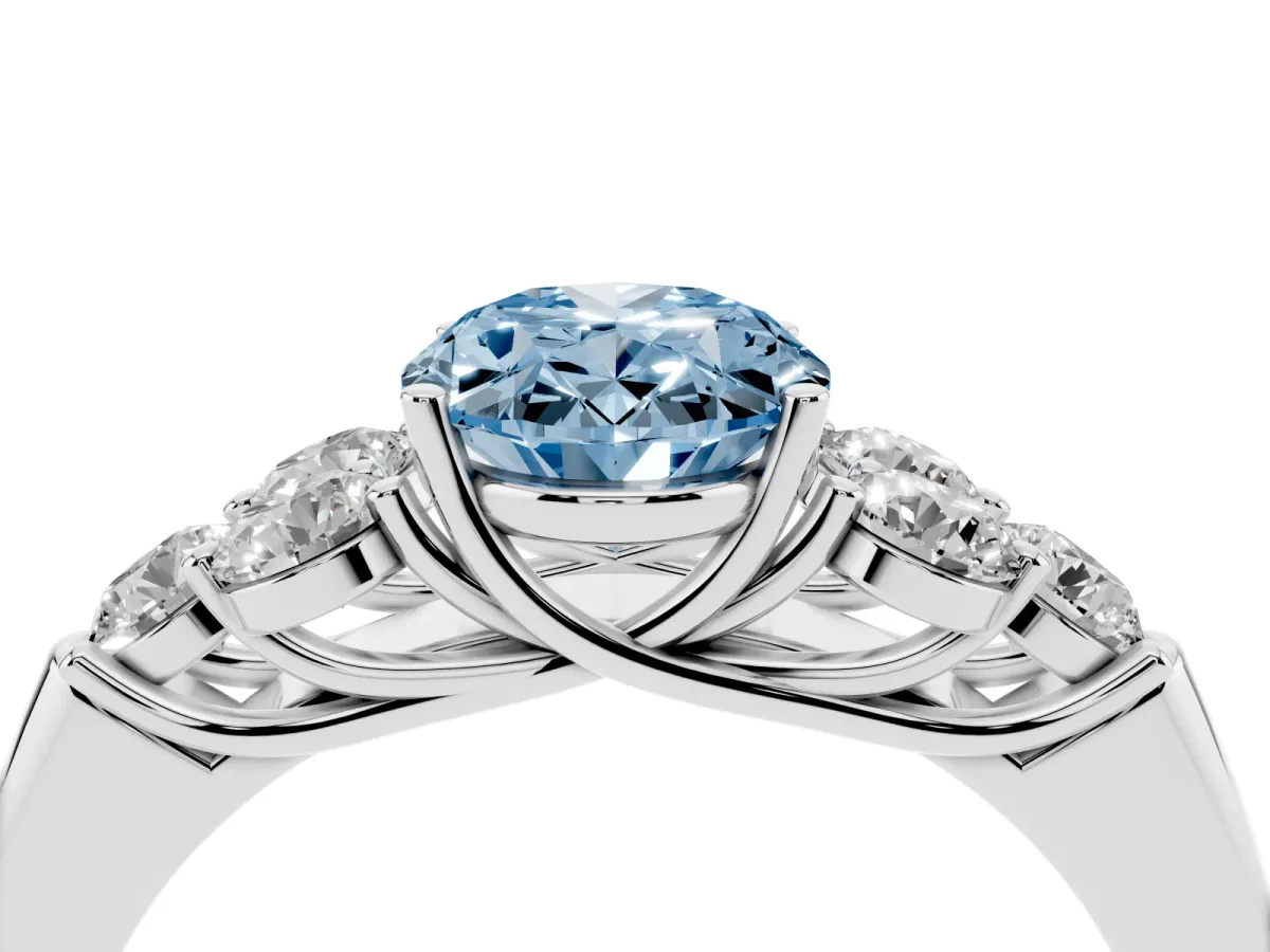 Fancy Blue Oval Cut Cut Diamond Cluster Ring with Round Accent Stones and Prong Setting on a Classic Band Silver