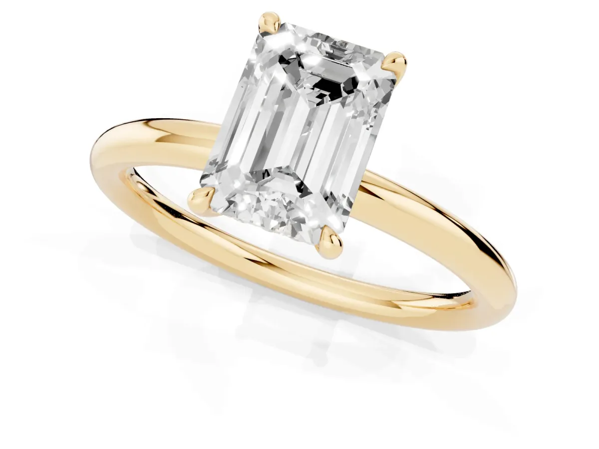 Emerald Cut Diamond Solitaire Ring with Thin Band and Four-Prong Setting Yellow gold