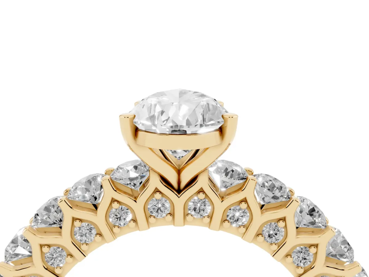 Pear Cut Diamond Solitaire Ring with Shared Prong Pavé Band and Four-Prong Setting Yellow gold