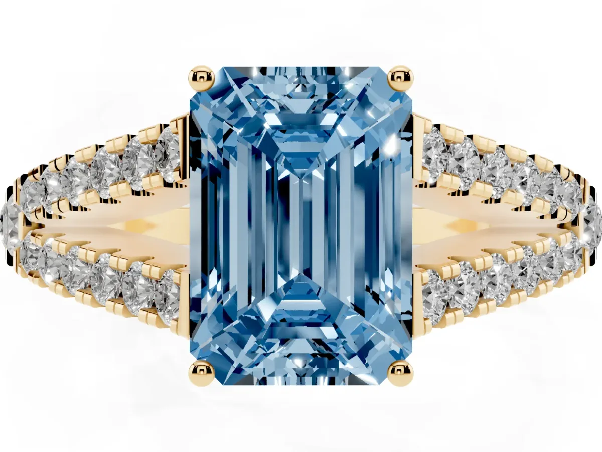 Fancy Blue Emerald Cut Diamond Split Shank Pavé Engagement Ring with Four-Prong Setting Yellow gold