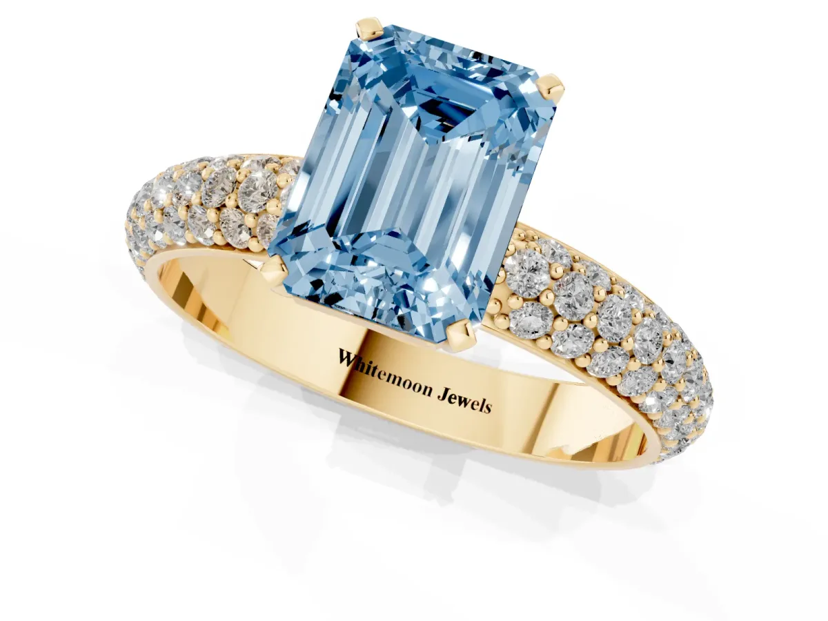 Fancy Blue Emerald Cut Diamond Solitaire Ring with Prong Setting and Pavé Band Yellow gold