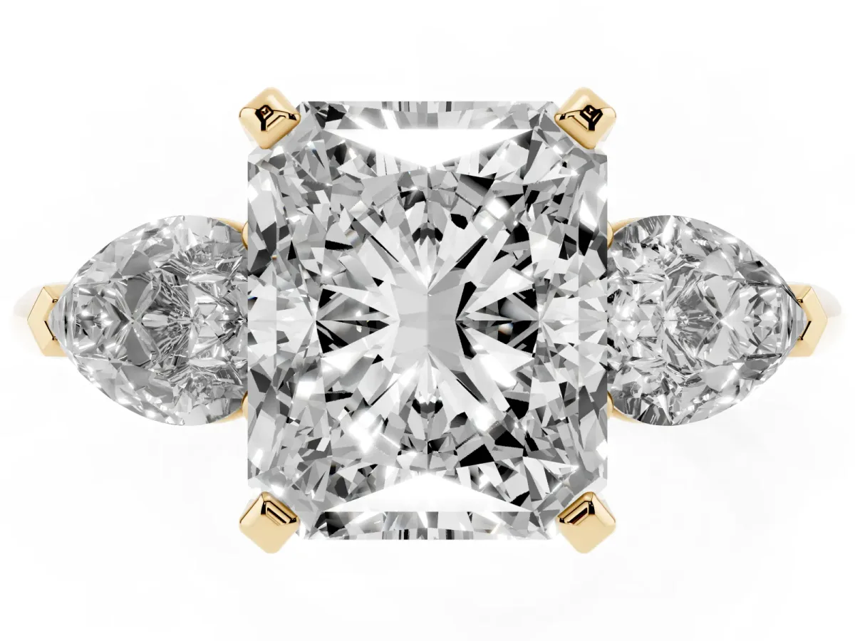 Three-Stone Radiant Cut Diamond Ring with Pear Side Stones and Four-Prong Setting Yellow gold