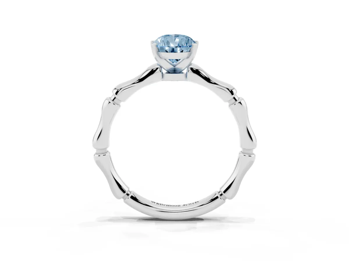 Fancy Blue Pear Cut Solitaire Diamond Ring with Bamboo Band and Four-Prong Setting Platinum