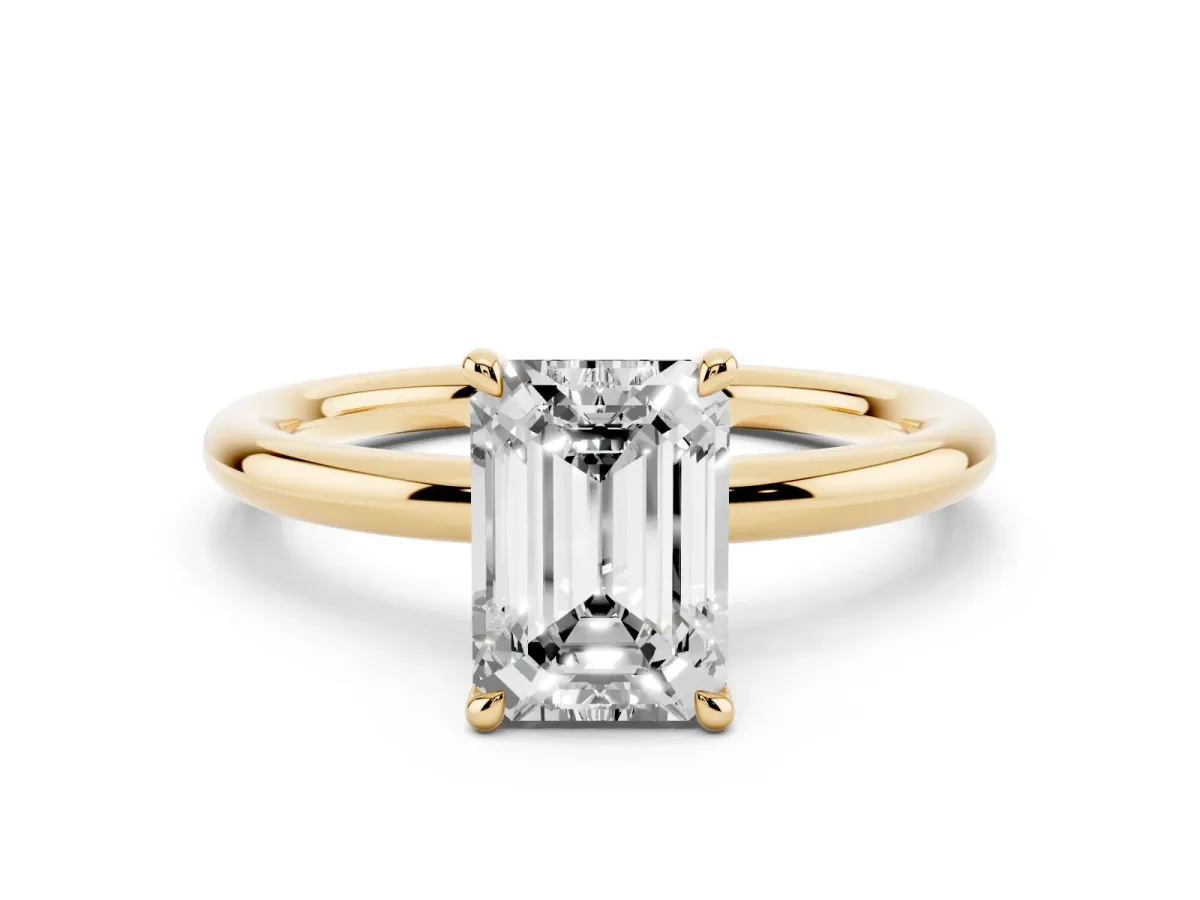 Emerald Cut Diamond Solitaire Ring with Thin Band and Four-Prong Setting Yellow gold