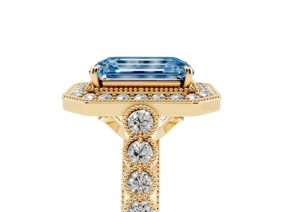 Fancy Blue Emerald Cut Halo Milgrain Solitaire with Bezel Set Side Stones and Pave Band Yellow gold