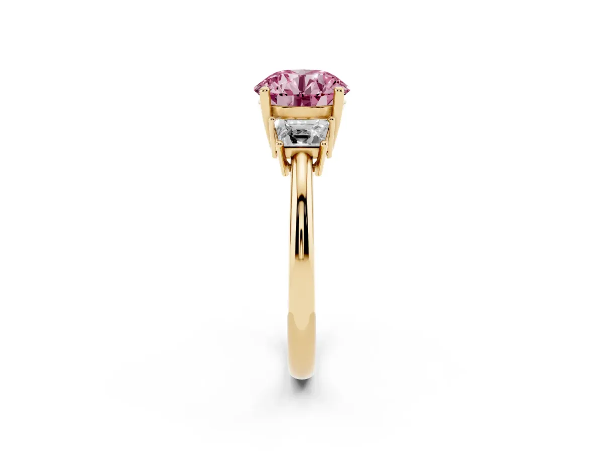 Fancy Pink Round Cut Diamond Three-Stone Ring with Trapezoid Side Stones and Prong Setting Yellow gold