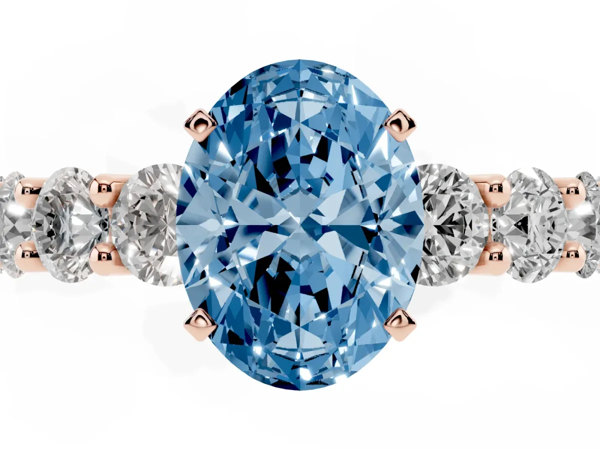 Fancy Blue Oval Cut Diamond Prong Setting with Side Stones on a Pave Band Rose gold