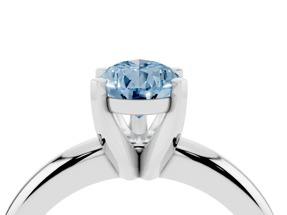 Fancy Blue Pear Cut Diamond Solitaire Engagement Ring with Round Band and Four-Prong Setting Silver