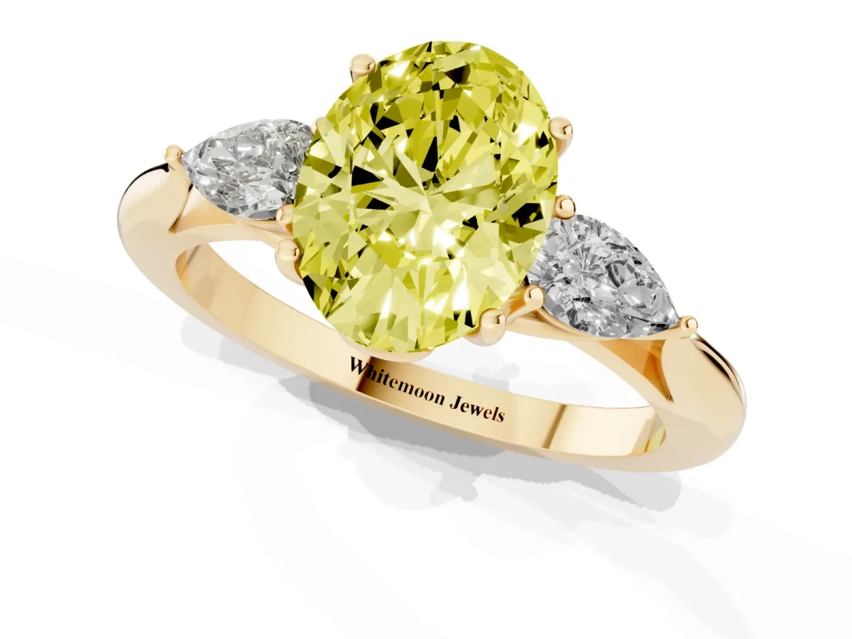 Fancy Yellow Three-Stone Oval Cut Diamond Ring with Pear Side Stones in Four-Prong Setting Yellow gold