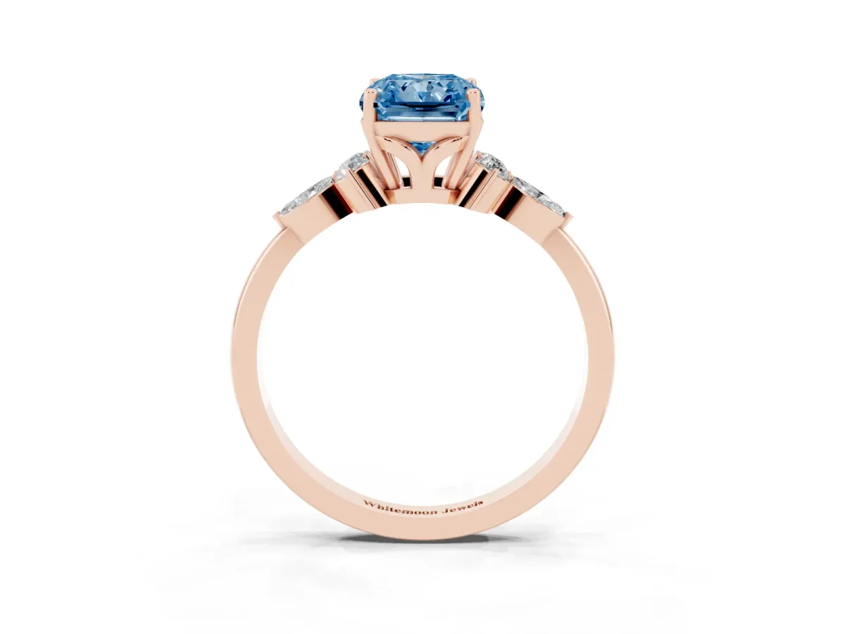 Fancy Blue Radiant Cut Brilliant Diamond Solitaire Ring with Pear Side Stones and Four-Prong Setting Rose gold