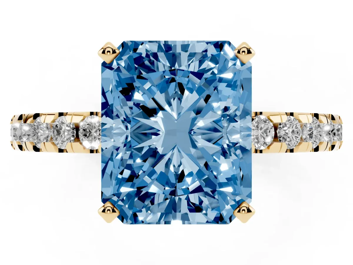 Fancy Blue Radiant Cut Diamond Solitaire Ring with Round Pavé Band and Four-Prong Setting Yellow gold